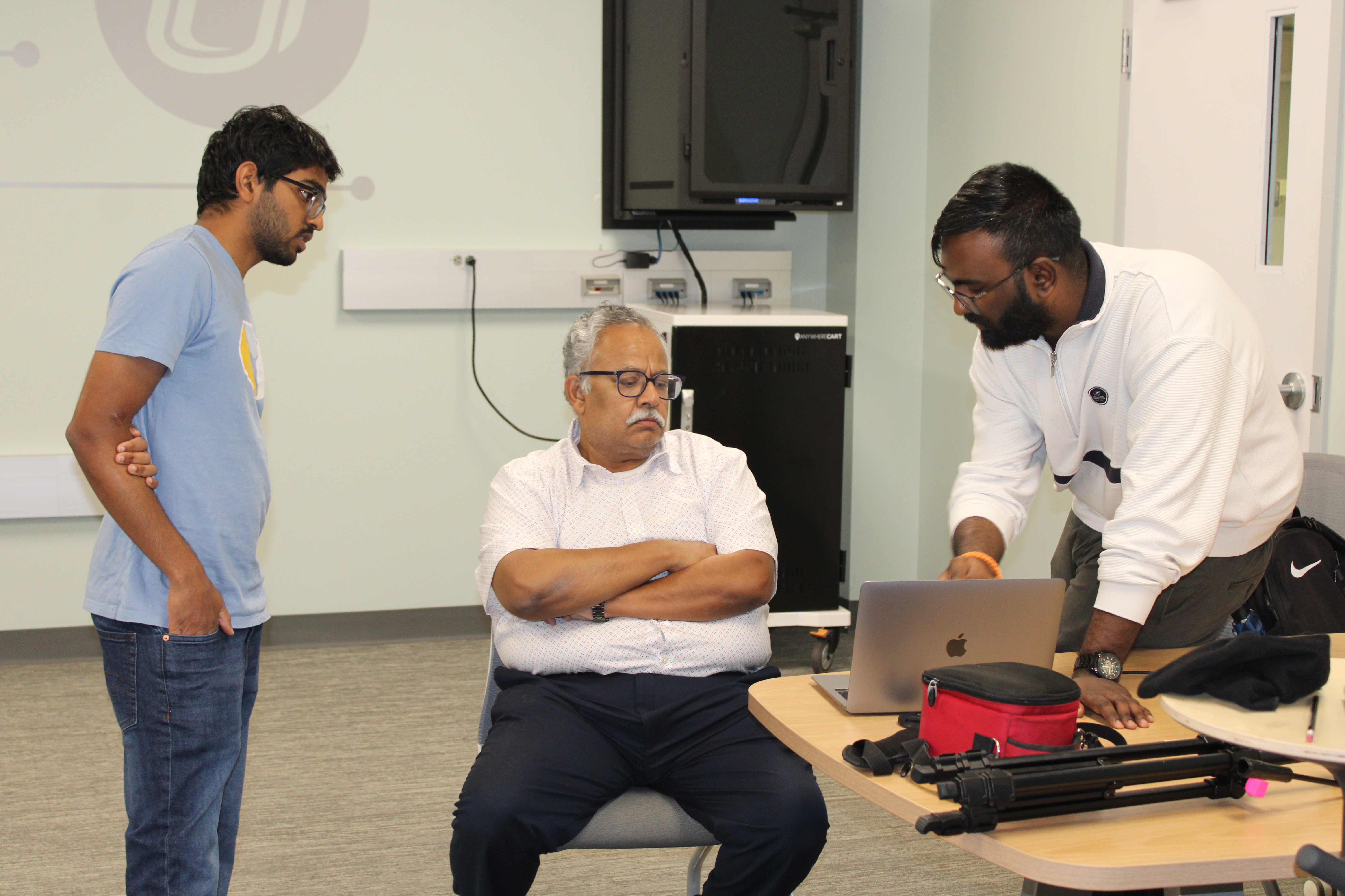 Teacher helping students with technology