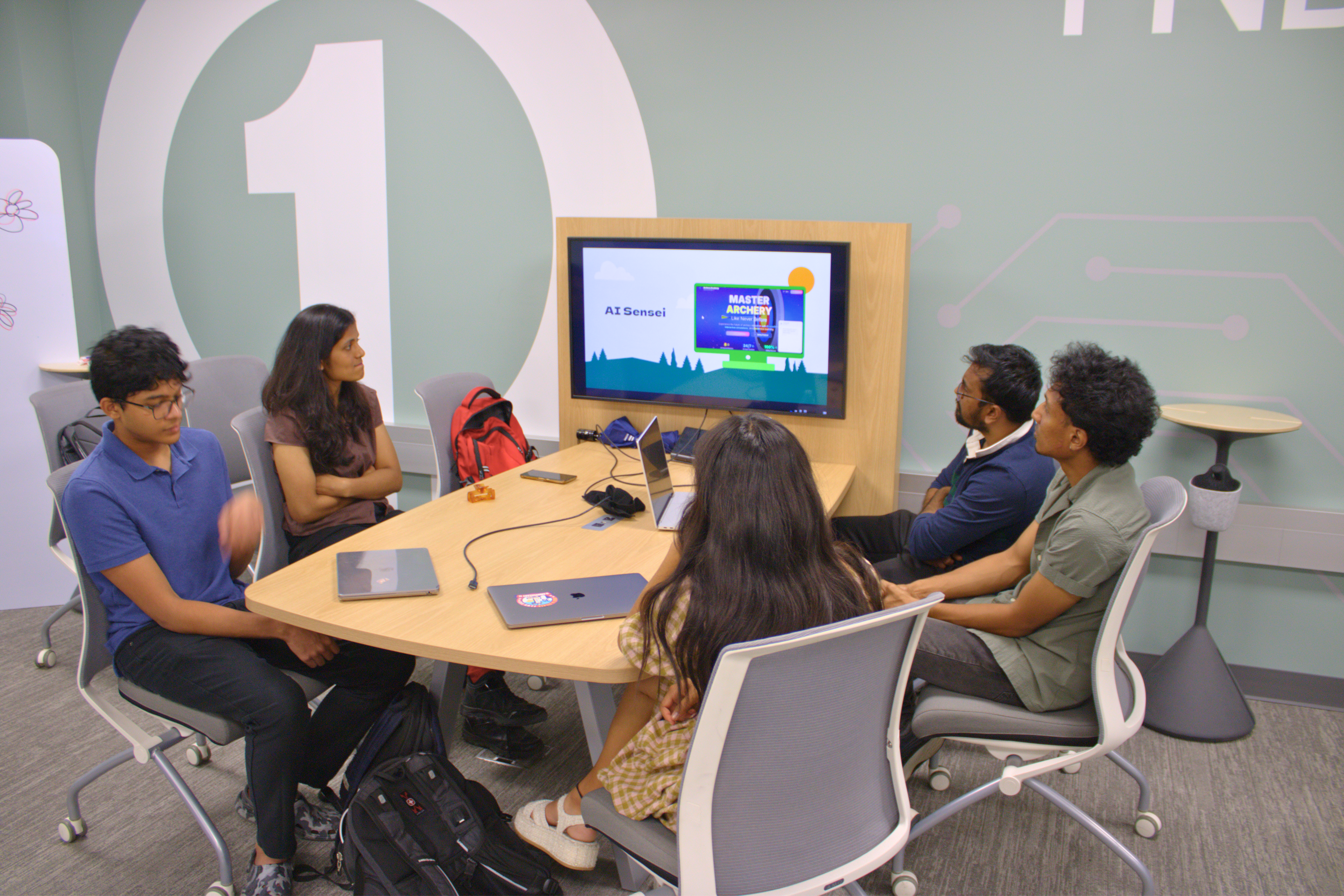 Participants working hands-on with laptops and AI tools during an AI-CCORE program at the University of Nebraska Omaha.