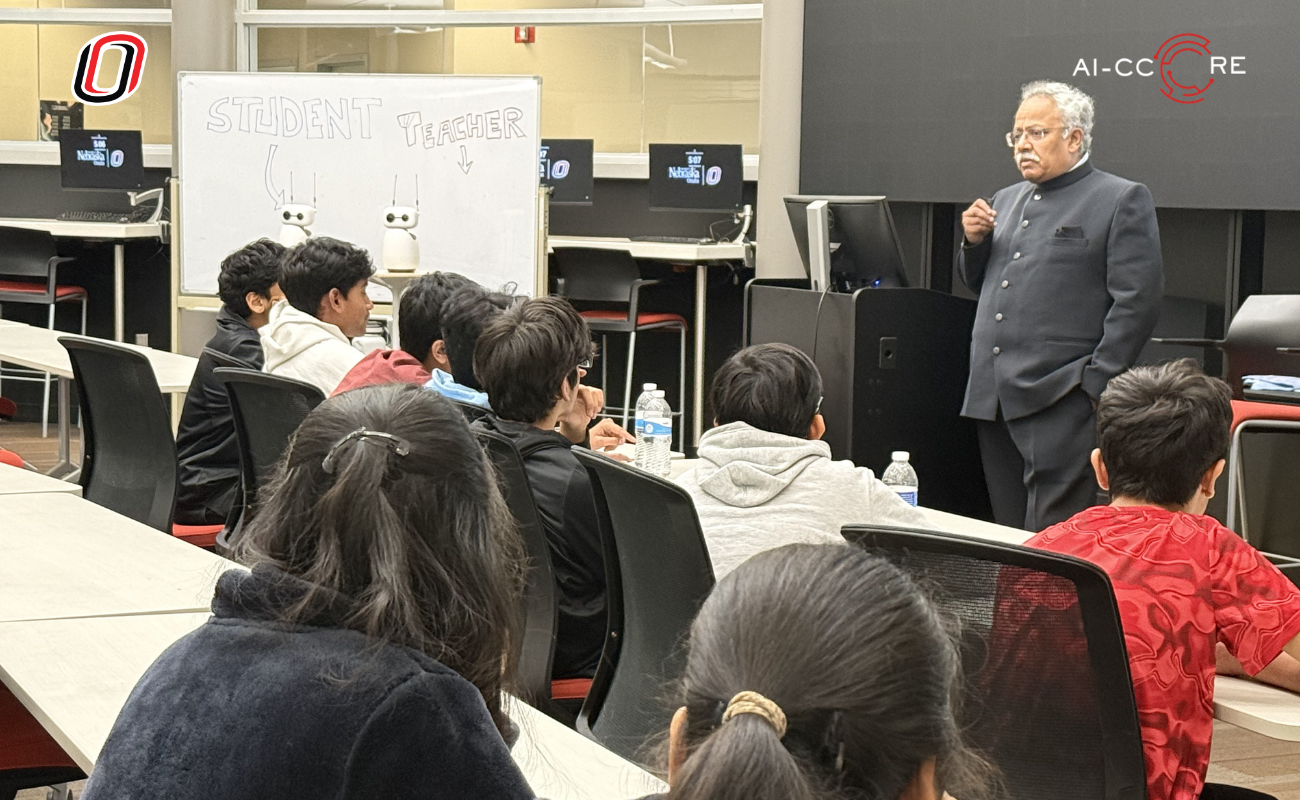 A seated audience watches a speaker present at a past University of Nebraska Omaha AI event with a presentation slide visible on screen.